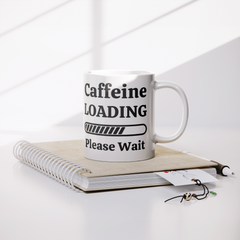 Caffeine_Loading-11oz_Ceramic_White_Mug_Lifestyle_Notebook_Mockup.png_15871104